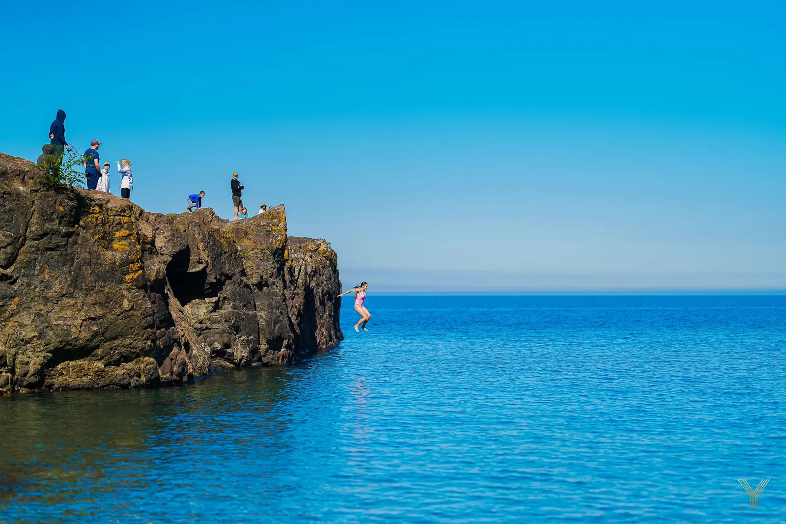 Cliffs meeting deep blue water on the lakeshore