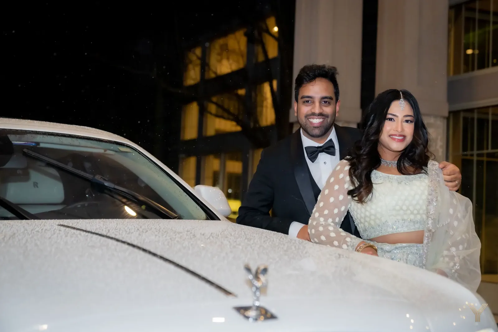 Couple beside a vintage car after the reception