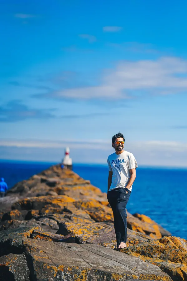 Traveller standing on a rocky outcrop by the lake